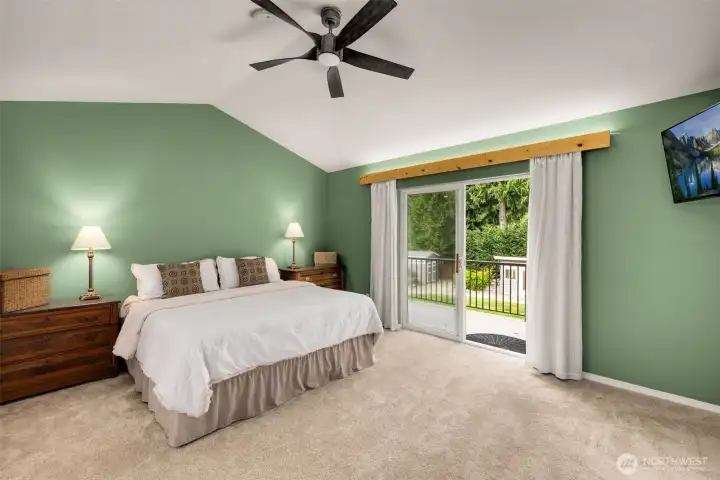 Primary suite with en-suite bath, soaking tub, walk-in closet, and private balcony over looking the backyard oasis.