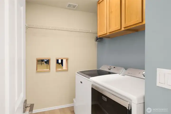 Laundry room conveniently located on second level next to bedrooms. Notice the laundry chutes from the primary walk-in closet!