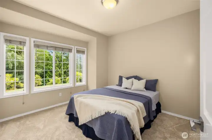 Bedroom #4 located on main level with attached bathroom, perfect for guests or when one-level or separate space is needed.