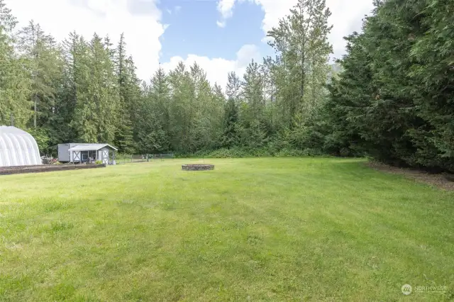 Level and private backyard complete with firepit, raised garden beds and chicken coop..