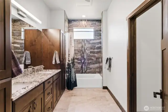 Shared full bath with a private toilet area