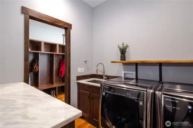 Laundry room with entrances from the primary closet and the hallway