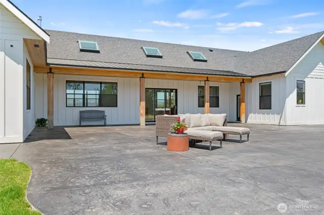 Large patio with 3 points of entry from house and view of the arena