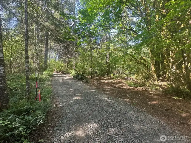 New driveway running through property to building site at back.