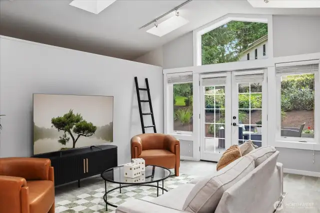 This spacious room has french doors that open to a side yard. This home has so many spaces to not only enjoy the outdoor views, but to also enable bringing the outdoors, in.