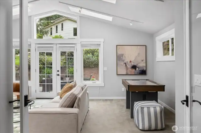 This spacious room has french doors that open to a side yard. This home has so many spaces to not only enjoy the outdoor views, but to also enable bringing the outdoors, in.