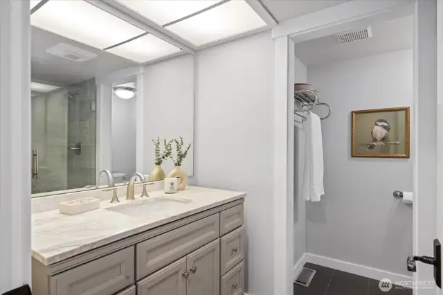 Guest bath with a gorgeous, updated vanity and tiling.