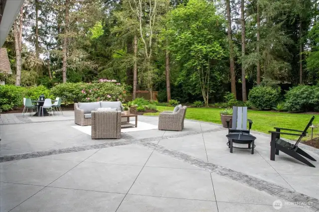 Spacious backyard with stamped concrete and stone pavers add architectural intrigue great to create multiple outdoor spaces.