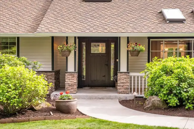 Welcome covered entry with a newer craftsman-style front door.
