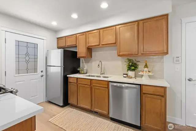 New quartz counters and tile backsplash