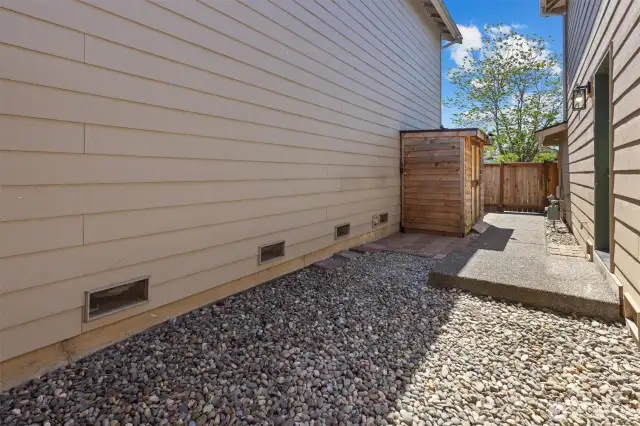 Easy maintenance fenced side yard with 2 storage sheds.
