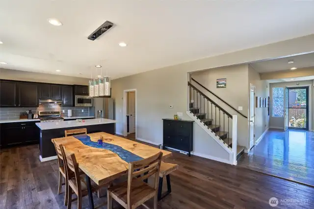 View of main level with upgraded iron railing to wide stair case to loft