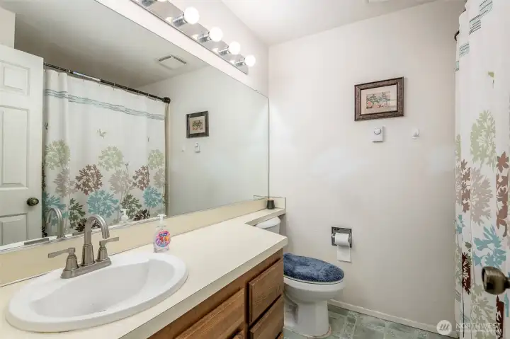 Full bath in hallway with soaking tub.