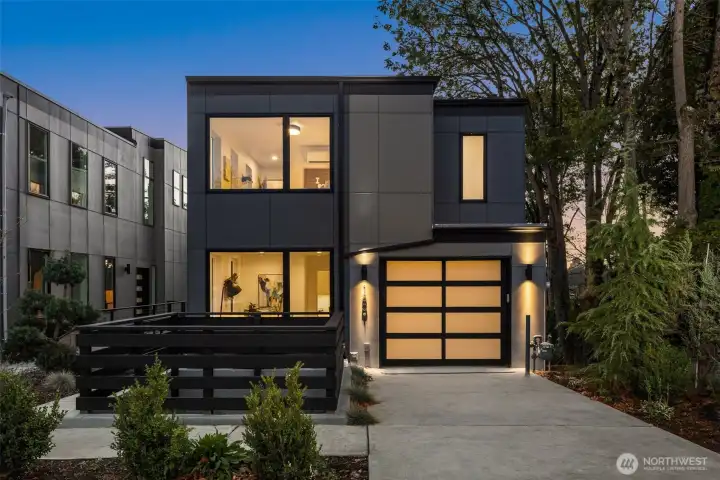 A stunning architectural masterpiece surrounded by greenery—this brand-new Mount Baker home glows from within. Its bold modern lines and warm natural materials blend seamlessly into the treetop setting, creating a serene retreat in the city.