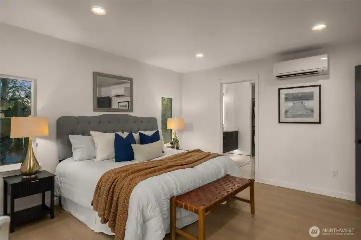 The primary suite feels like a private luxury retreat in the trees. Enjoy your own fireplace, a secluded patio, and a spa-inspired ensuite where natural light and modern design merge for true relaxation.