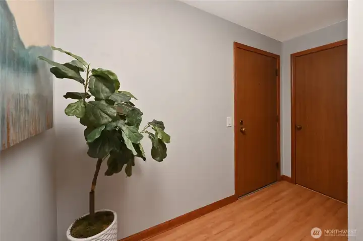 A spacious and welcoming entryway featuring warm wood finishes, setting a serene tone the moment you arrive home.