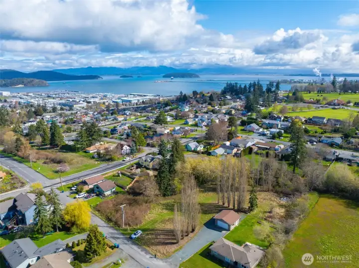 Sweeping aerial view of Anacortes highlighting the marina, neighborhoods, and island-dotted shoreline.