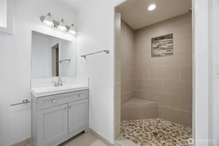 Guest bath w nice sit down tiled shower.