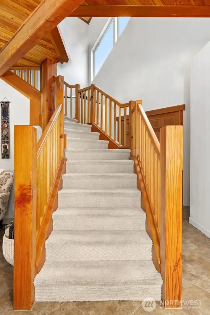 The solid wood stairway leading to the primary suite is a work of art.
