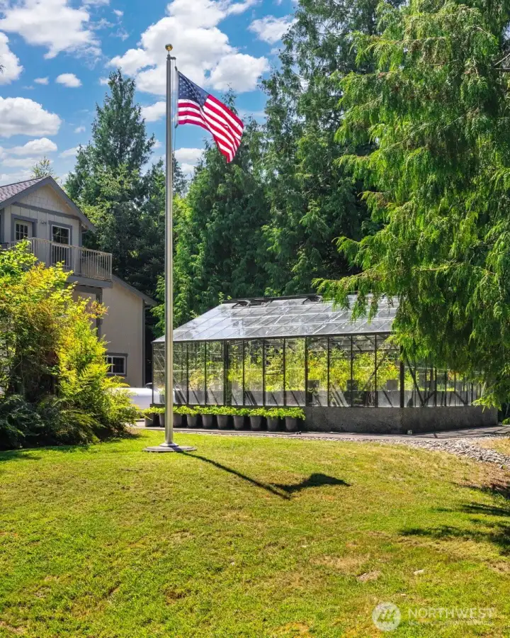 Looking at the stunning greenhouse and majestic flag pole.