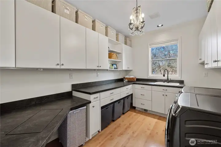 Versatile laundry room has a sewing desk. Craft room too?