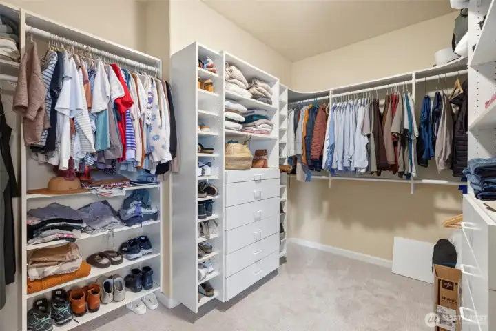Primary closet with custom shelving system. Primary closet with custom shelving system.