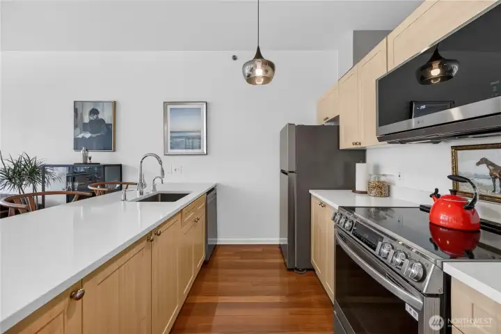 The kitchen has newer quartz countertops and stainless steel appliances that all stay with the sale.