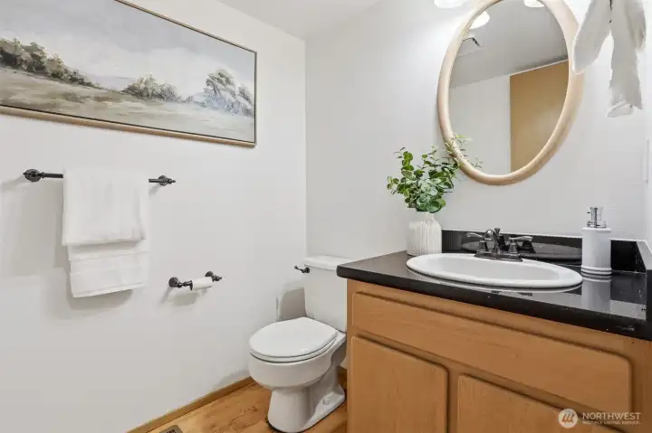 Main level powder room with hardwood floors. Main level powder room with hardwood floors.
