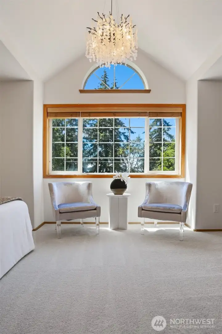 Vaulted ceiling in the primary bedroom with ornate light fixture. Vaulted ceiling in the primary bedroom with ornate light fixture.