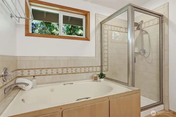 Primary bath has ceramic accents, jetted soaking tub and stand along shower. Primary bath has ceramic accents, jetted soaking tub and stand along shower.