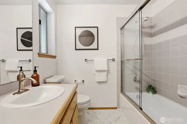 Upper level full hall bath has ceramic tile enclosure with glass doors. Upper level full hall bath has ceramic tile enclosure with glass doors.