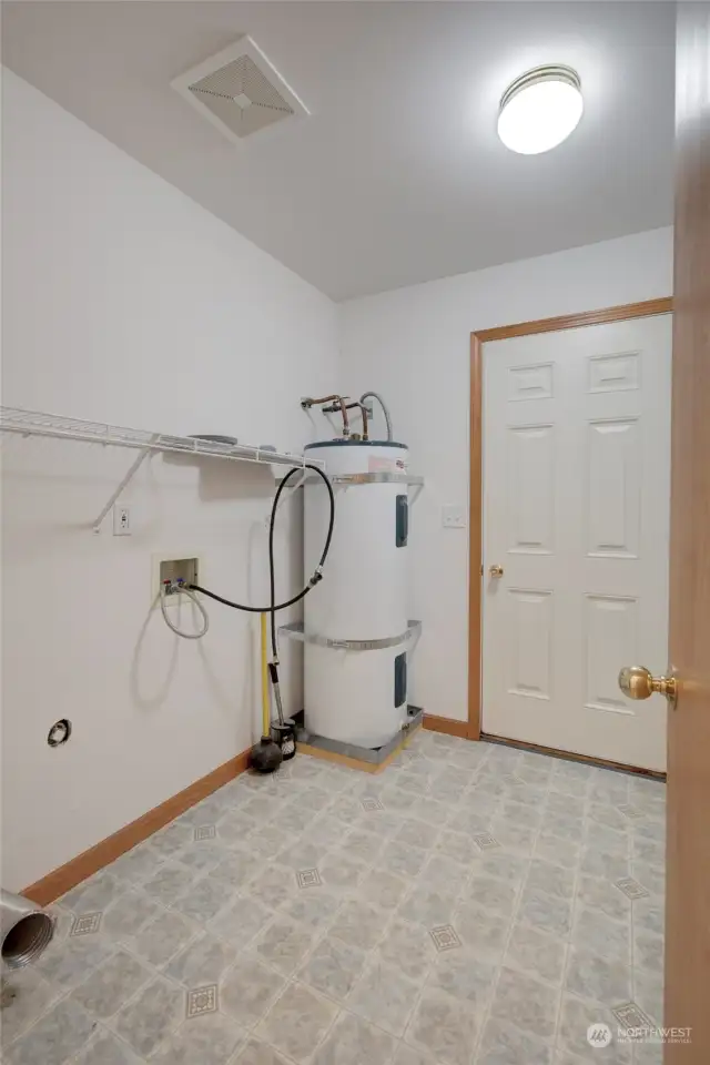 Just past the kitchen is the laundry room, and side door entrance to the home.  This is the door you will likely use coming from your garage.