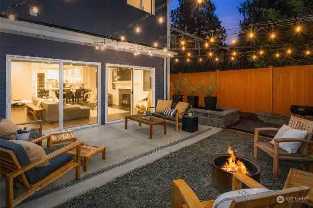 Step outside on to your beautiful back yard with tons of space for seating, enjoying a fire, and a designated BBQ area that would be great for a hammock too!