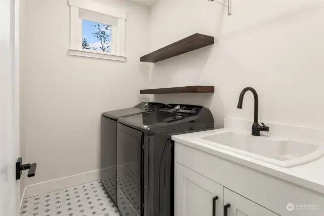 The large laundry room has extra storage space, a utility sink and is conveniently located on the second floor with the bedrooms!