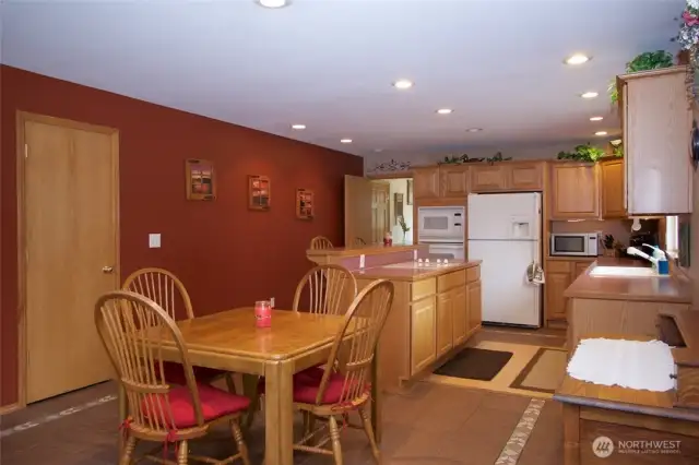 Beautiful oak kitchen, decorative tile flooring, recessed lighting, island cooktop, open floor plan!