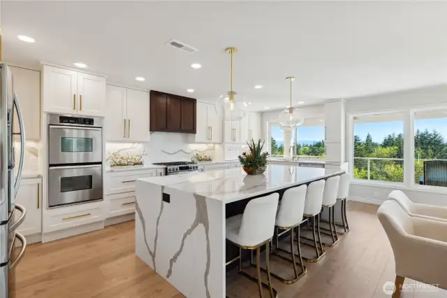 New professionally designed gourmet kitchen with custom cabinets, drawers and pull-outs. Solid slab granite and back splashes. Double ovens, six burner gas stove, drawer microwave, French doors to huge entertainment deck.