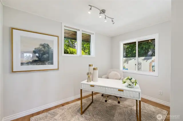 This second bedroom is being used as a Home Office.  There is a closet on the right.  This bedroom is across from the Primary suite.  If you look closely, you will see part of the Mediterranean inspired, private flowering gardens.
