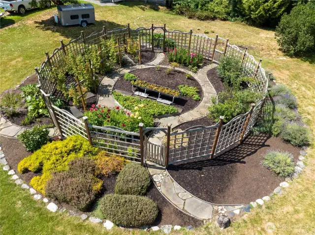 This is a well-designed organic garden with stone walkways!  The fencing helps to deter the Deer from enjoying the fruits of your labor!