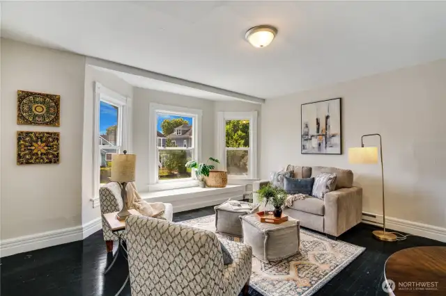 This inviting one-bedroom, one-bathroom upstairs unit features a delightful window seat in the bay window, providing the perfect spot to unwind. Beautiful hardwood floors and fresh paint enhance the timeless appeal of this comfortable living space.