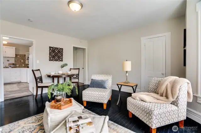 With enough room for a small dining table, this generous living area offers both flexibility and charm. The circular floor plan seamlessly connects the hallway to the kitchen, making entertaining effortless.