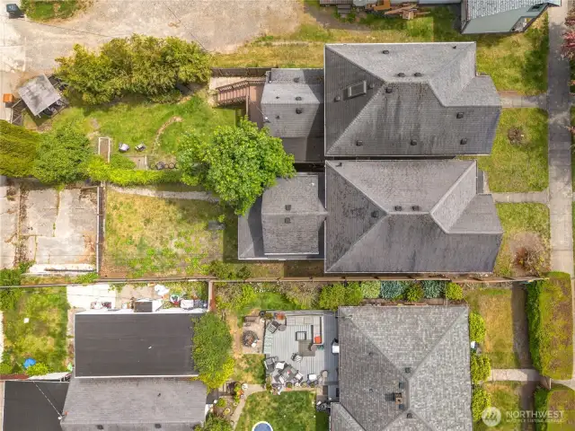 This bird's eye view showcases the spacious back yard and parking for this property.