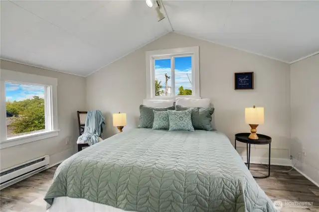 With new flooring, fresh paint, and three sun-filled windows, this bedroom offers a warm and welcoming atmosphere.
