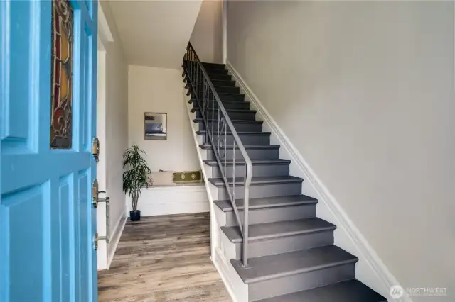 Fresh paint and flooring welcome you into this charming entryway. Let's first check out the downstairs two-bedroom, one-bath unit.