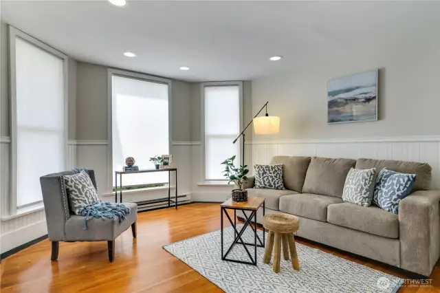 Bathed in natural light from three sun-filled windows, this spacious living room offers a warm and welcoming ambiance. Charming beadboard details and recessed lighting create a perfect blend of old and new, while fresh paint throughout ensures a move-in-ready experience.