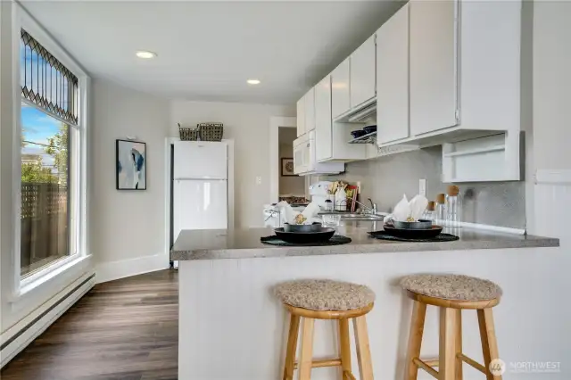 Designed for effortless entertaining and everyday convenience, this open floor plan seamlessly connects the eat-in kitchen to the living spaces.