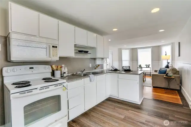 New luxury vinyl flooring makes kitchen cleanups effortless, combining durability with modern appeal. Add a small island to enhance storage and create a convenient prep space.