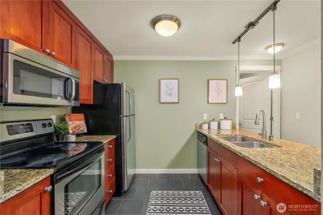 A cozy, yet generous sized kitchen is situated to your left as you enter the home