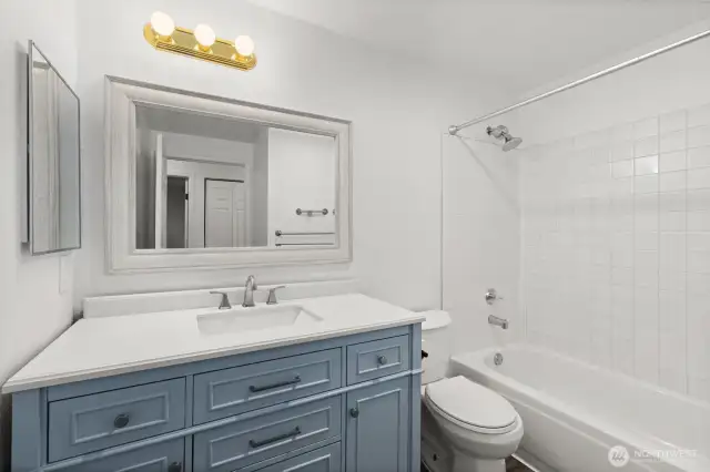 The guest bathroom features a sleek, updated vanity—offering a fresh, clean look.