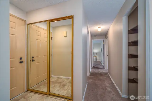 Step inside to a welcoming entryway with a large coat closet, plush carpet, and calming tones throughout.