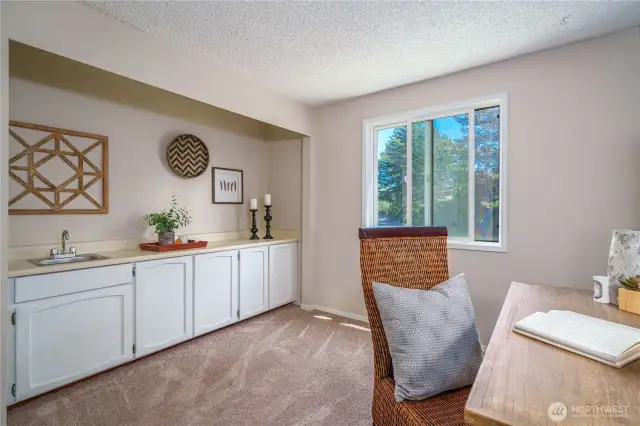 Complete with cabinetry and a sink, this space could also be converted to a third bedroom with ease.